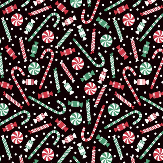 Candy canes and Christmas sweets on black